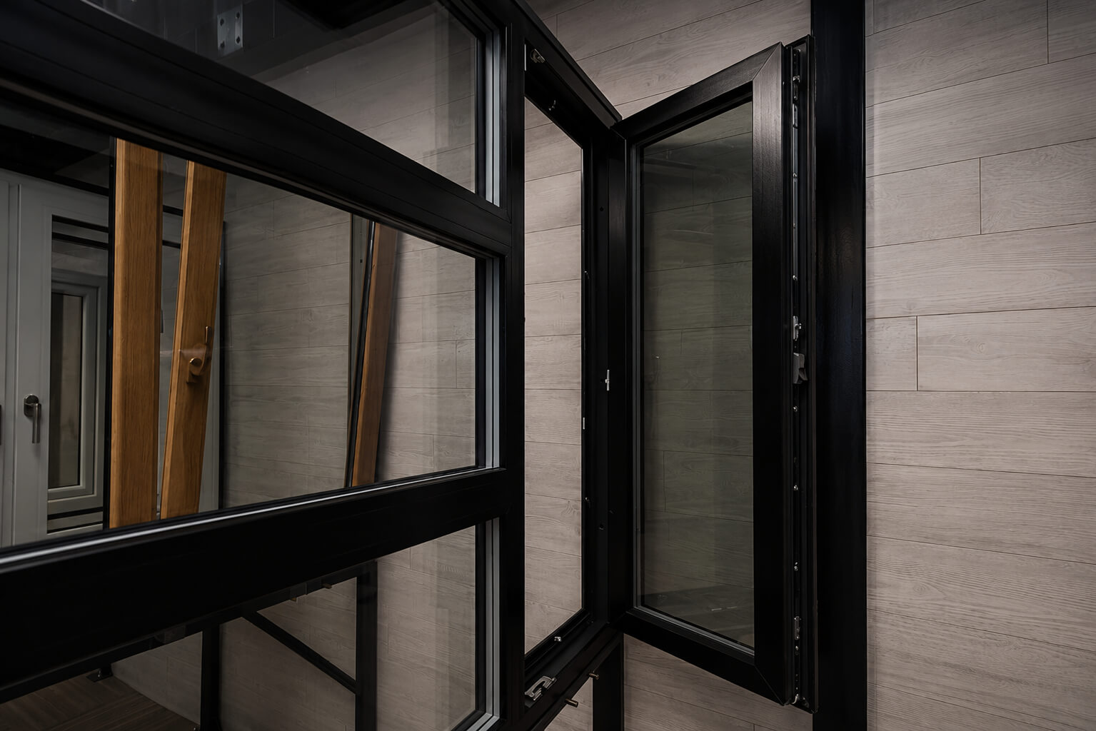 Black Tilt & Turn window shown open in the EDKAN showroom in Saint-Eustache